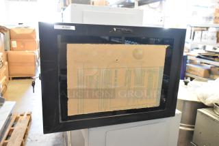 Brand new black metal enclosure system with lockable door, labeled "AUS07," protective cardboard insert visible.