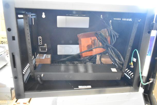 Brand new black metal enclosure system, open frame, includes cables and hardware. Tags visible. Ideal for secure housing.