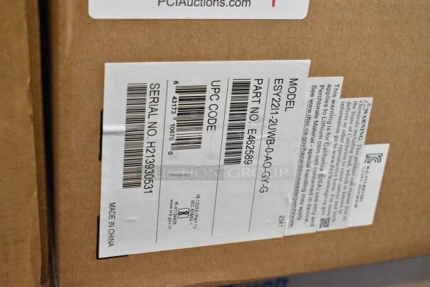 Brand new EloTouch ESY22I1-2UWB-0-AO-GY-G display box. Label shows model, part, serial number, and UPC code. Made in China.