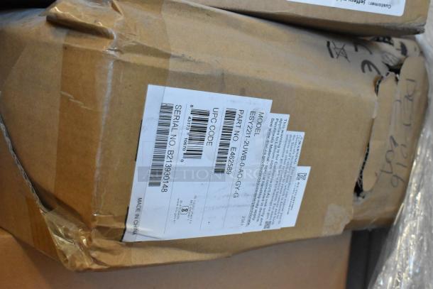 Two brand new EloTouch displays in box, model ESY22I1-2UWB-0-AO-GY-G, showing labels and serial number B213301248.