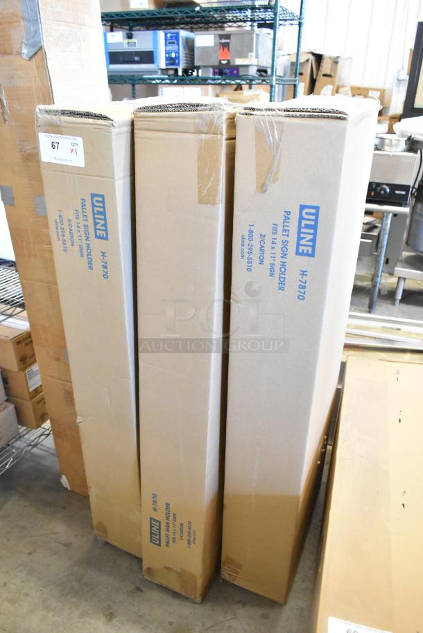 Three new Uline H-7870 Pallet Sign Holders in original packaging. Boxes display product name and dimensions.
