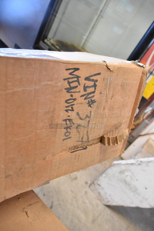 Brand new MIN-012-EK01 unit in box. Visible handwritten label reads "VIN# 327"," likely indicating identification details.