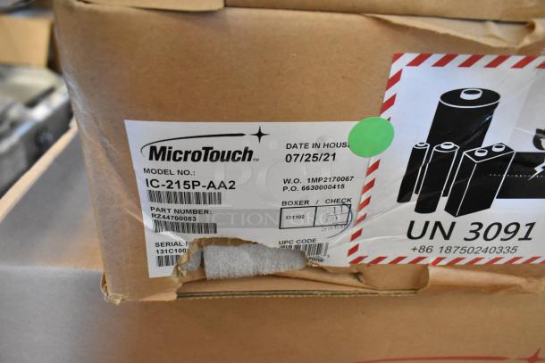 Brand new MicroTouch IC-215P-AA2 monitor in box. Label shows model, part, serial numbers, and date in house 07/25/21.