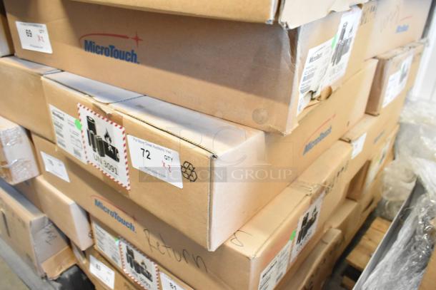 Boxes of brand new MicroTouch IC-215P-AA2 monitors, sealed, labeled with shipping and product information.