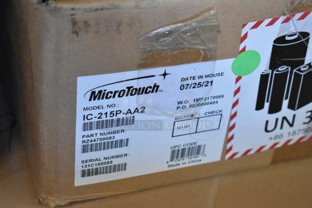 Brand new MicroTouch IC-215P-AA2 monitors in box, model details and barcodes visible.