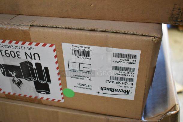 Brand new MicroTouch IC-215P-AA2 monitor in unopened box with labels showing model and serial number.