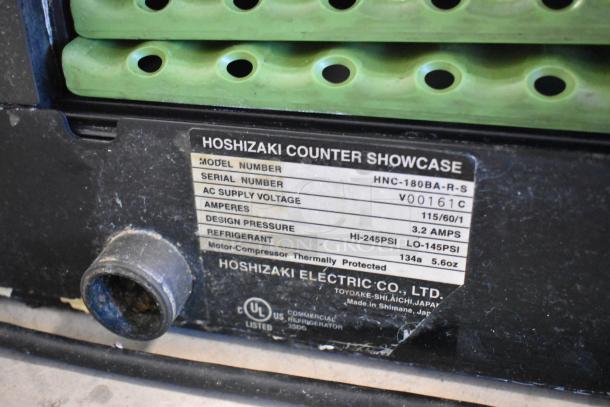 Hoshizaki HNC-180BA-R-S stainless steel sushi display case with label showing 115 volts, 3.2 amps, refrigerant R134a.