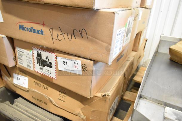 Two brand new MicroTouch IC-215P-AA2 monitors in original boxes, labels showing model and quantity, marked "Return."