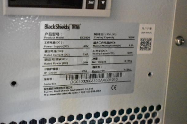 Alt text: BlackShields DC0300 white metal cabinet, new, with product label detailing cooling capacity, power supply, rated current, IP55.