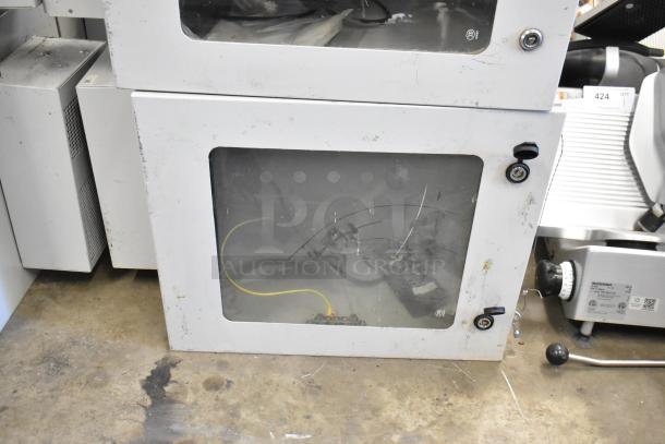 Two BlackShields DC0300 white metal cabinets, brand new, one missing key, visible wiring inside, stackable design.
