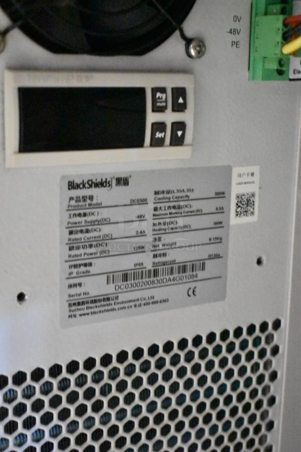 "BlackShields DC0300 white metal cabinet, new condition, one missing key, detailed label showing specifications and serial number."