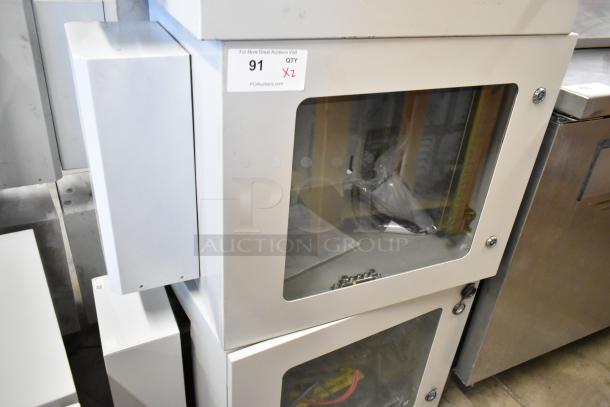 2 new BlackShields DC0300 white metal cabinets, glass doors, missing keys, auction tag visible.