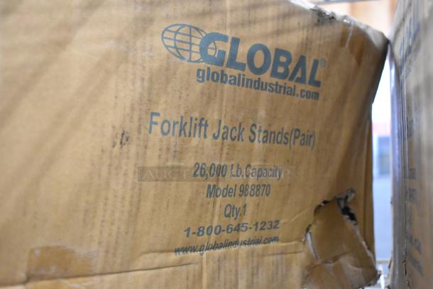Brand new Global 988870 forklift jack stands, pair, 26,000 lb capacity, visible packaging with product details and contact info.