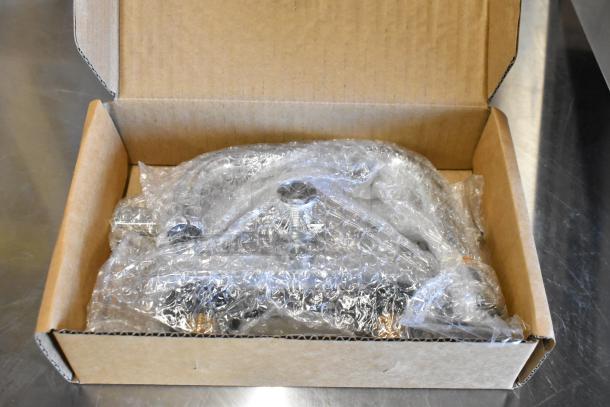 Box containing a new Advance Tabco 7-PS-56 stainless steel single bay sink, wrapped in bubble wrap.
