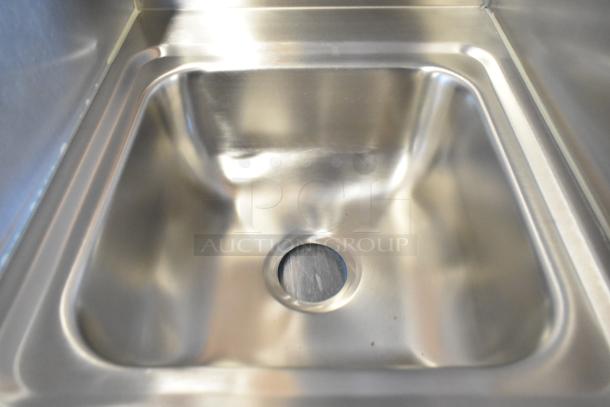 Brand new Advance Tabco 7-PS-56 stainless steel single bay wall mount sink, shown with open drain and sleek finish.
