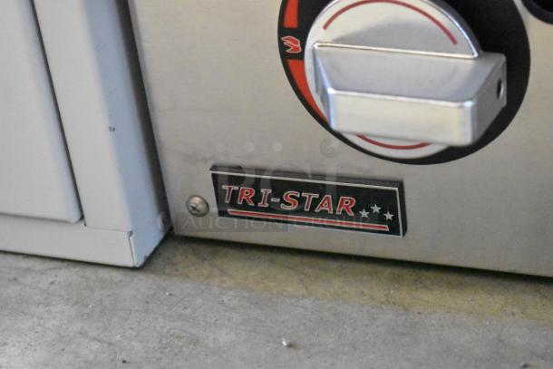 Brand new 2022 Tri Star TSGGM-18i stainless steel natural gas flat top griddle, showing brand logo and control knob.