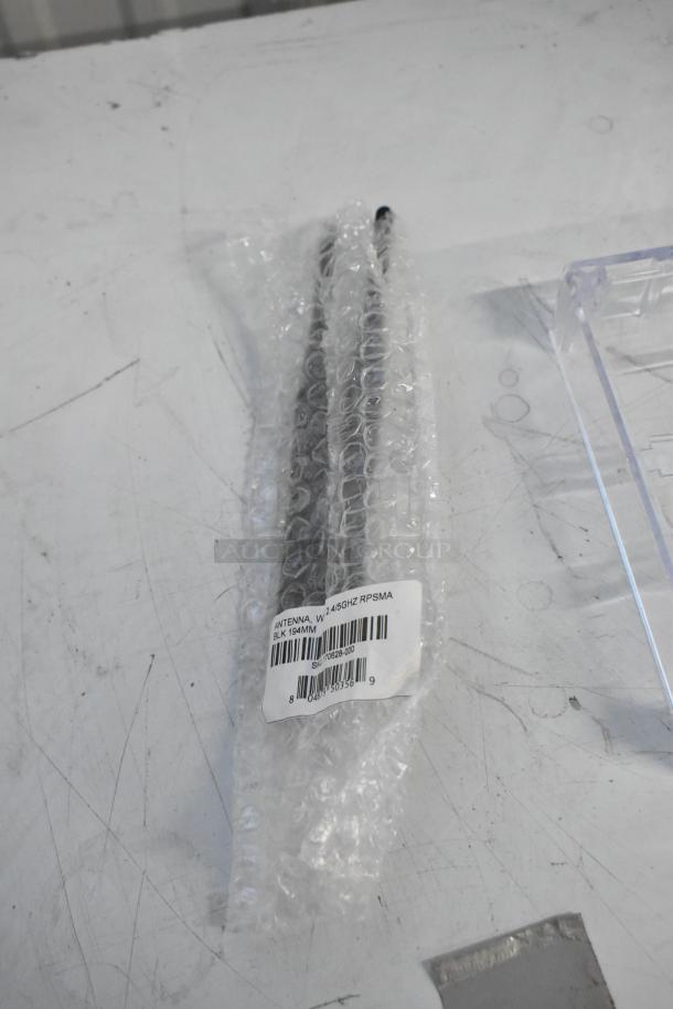 Brand new lot including antenna, 2.4/5GHz RPSMA, 194mm, pipe mounting kit, and outlet box cover sealed in bubble wrap.
