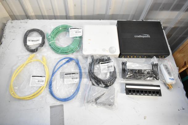 Brand new lot with Cradlepoint AER2200, Ruckus Access Point, wiring, Ethernet cables. Items in original packaging.