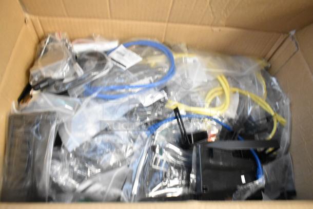 Brand new box with Cradle Point AER2200 unit, Ruckus access point, wiring, and cables, shown packaged together.