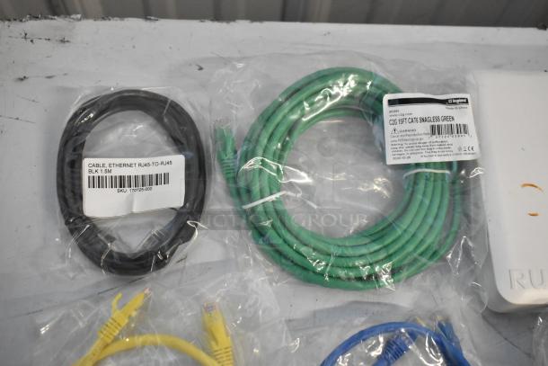 "Brand new cables in packaging; includes black RJ45 cable, green C2G Cat6 cable, Ruckus access point corner visible."