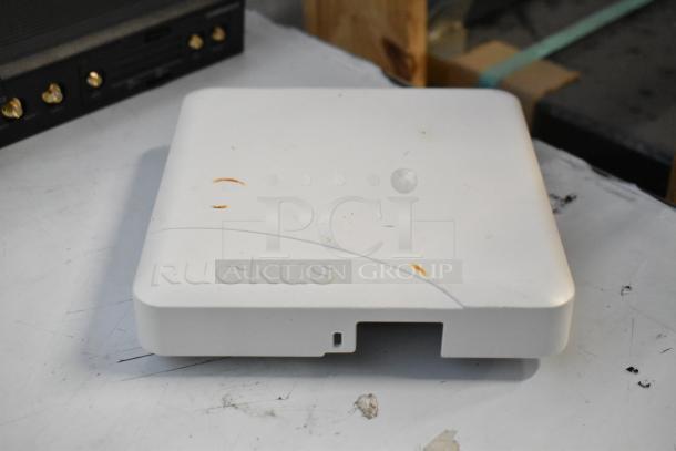 Brand new Ruckus access point, white with minor marks, part of a lot including Cradle Point AER2200 and wiring.