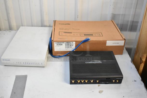 Cradle Point AER220 router, Avigilon Embedded NVR, and box of wires. Router box marked AER series. Bidding lot of 3 items.