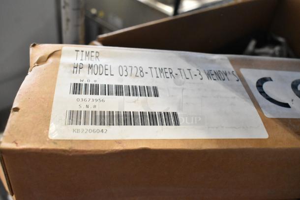 Box containing HP 03728-TIMER-TLT-3 three lane timer, new condition, with labels showing model and serial numbers.