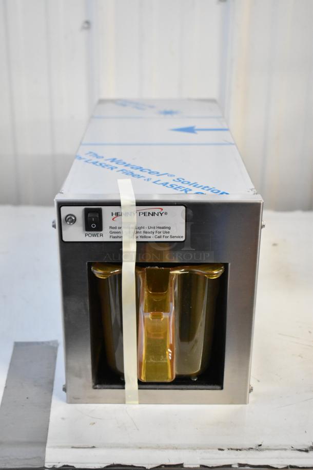 Brand new Henny Penny MPC-1L stainless steel holding bin in box. 110V, 1 phase. Power switch and status lights visible.