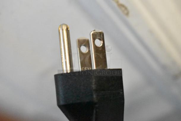 Close-up of a standard U.S. 110V electrical plug, implying the appliance's connection type.
