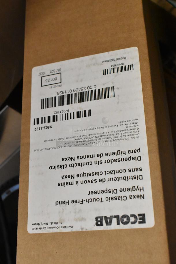 Four new Ecolab Nexa Classic Touch-Free Hand Hygiene Dispensers in sealed boxes. White shipping label with barcode visible.