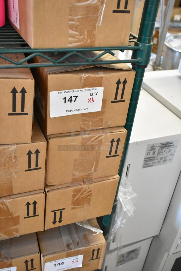 6 Ecolab Nexa Touch Free Hand Hygiene Dispensers. New in box, stacked on shelf. Auction details label visible.