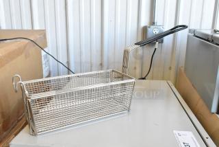 Brand new metal fry basket with long handle and mesh design, perfect for commercial kitchen use.