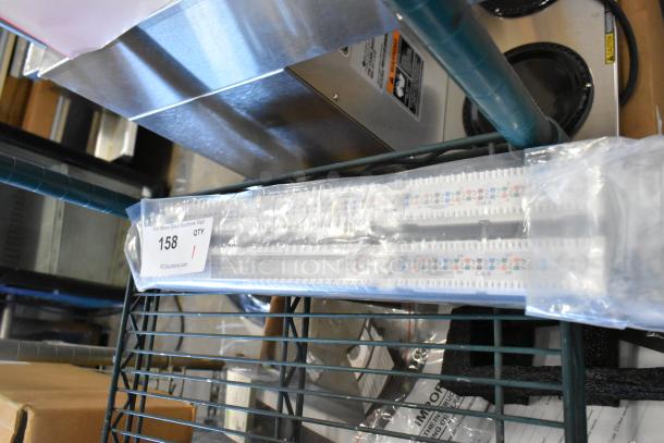 Tripp Lite 48 Port Panel new in packaging, mounted on shelf. Label indicates item number 158 for auction listing.