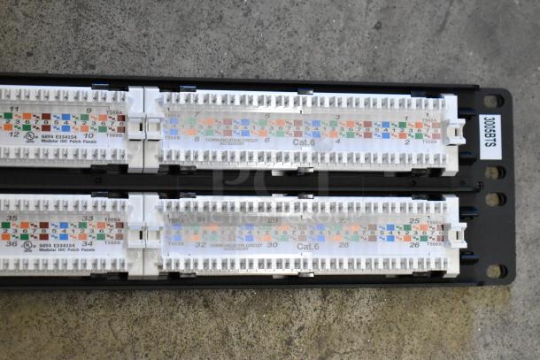 Tripp Lite 48 Port Panel, Cat6, modular IDC patch panel, marked "3006BTS," condition appears good, ideal for network setups.