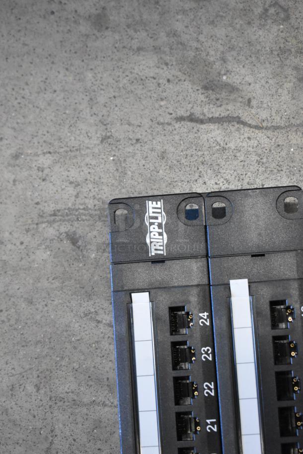 Tripp Lite 48 Port Panel, black, features numbered ports for easy organization, Tripp Lite branding visible, in good condition.