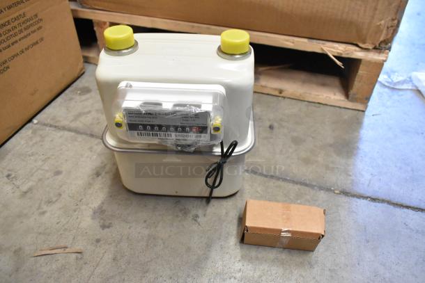 Brand new EKM Metering EKM-PGM.75 electric meter in box. Includes four meters, model details visible.