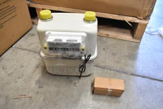 Brand new EKM Metering EKM-PGM.75 electric meter in box. Includes four meters, model details visible.