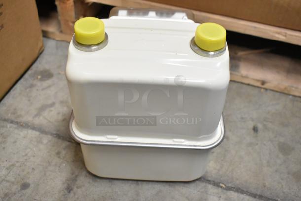 Four new EKM Metering EKM-PGM.75 electric meters in box, white casing, with yellow caps.