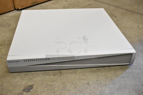 Brand new Avigilon VA1908D HD Video Appliance, in box, sleek design, pristine condition, labeled for easy operation.