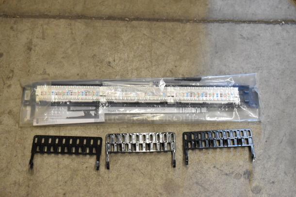 Three brand new Tripp Lite N252-024 Cat6 patch panels in packaging, featuring keyhole mounting slots.