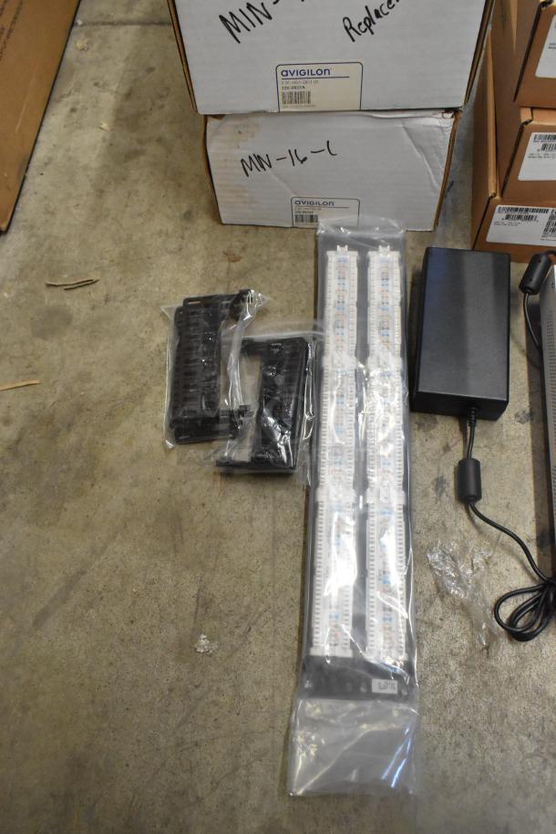 Lot of 10 brand new items including Avigilon VMA-ENVR1-8P8 and Cradlepoint, in original packaging. Boxes labeled with Avigilon branding.