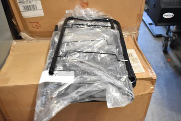 Brand new black metal mesh rack, in original packaging, resting on a cardboard box. Ideal for storage or display.