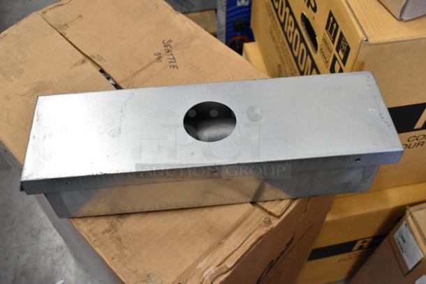 Two brand new metal items: wall mount shelf and box, both with a sleek, silver finish. Wall mount has a round cutout.