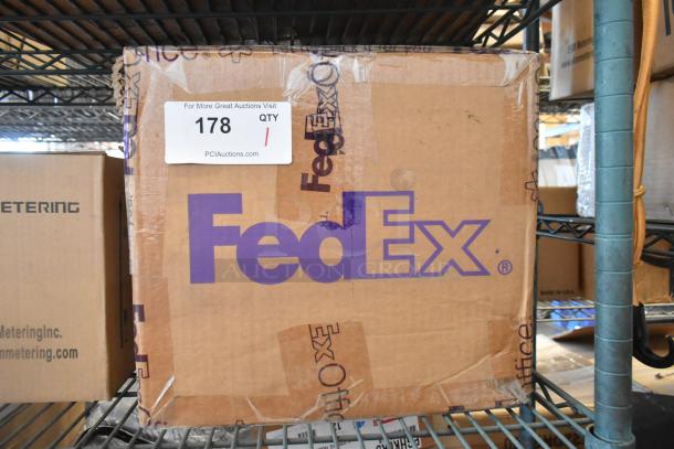 New Cradlepoint AER2200 Series Router in sealed FedEx box, labeled with auction tag 178 from PCIAuctions.com.