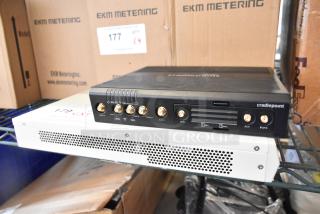 Brand new Cradlepoint AER2200 router and Avigilon embedded NVR on a shelf, auction item, doubling bid value.