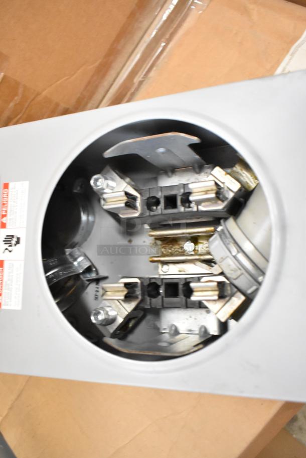 Talon Meter Socket, new, metal construction, with visible internal connections. Label indicates specifications and safety warnings.