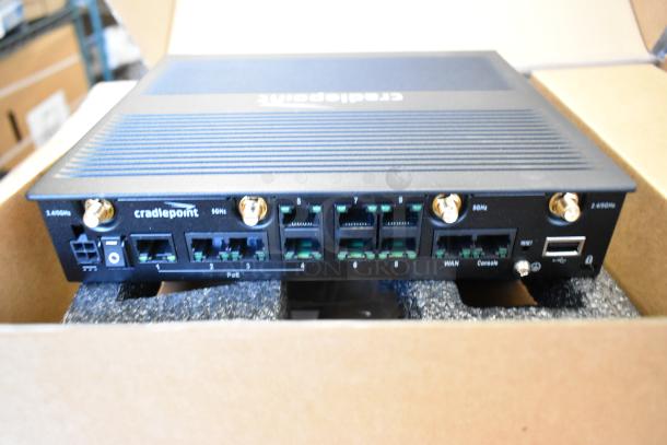 Brand new Cradlepoint AER Series Router in box, showing multiple ports and antenna connections. Model and specifications visible.