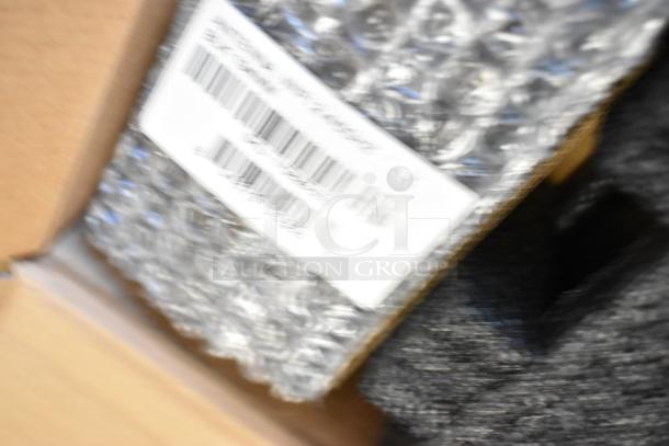 Brand new Cradlepoint AER Series Router in box, with visible bubble wrap and barcode label.