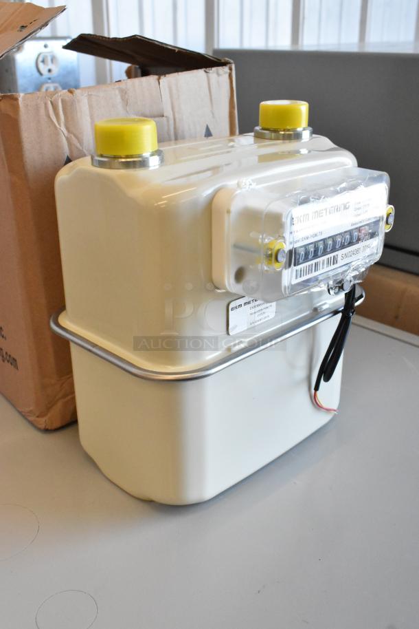 Brand new EKM Metering EKM-PGM.75 electric meter, in box, pristine condition, features clear display and connection wires.