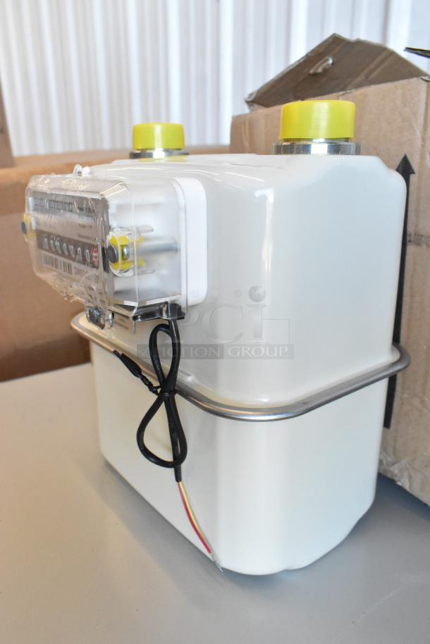 Brand new EKM Metering EKM-PGM.75 electric meter, in box. Features clear display, yellow caps, and wiring.